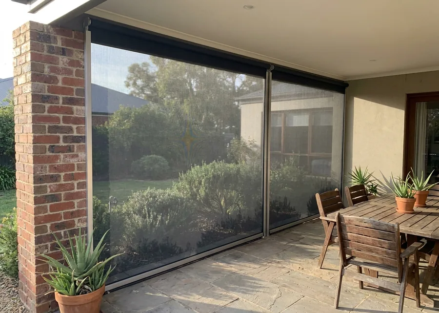 Charcoal zip screen held taut in side channels across a Menlo Park patio opening, the garden still visible through the mesh